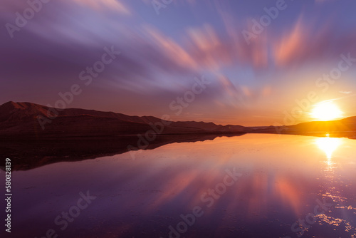 Beautiful sunset over the lake with reflection . Panoramic sunset landscape.