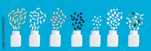 Composition of various multicolor capsules, herbal vitamin pills or drugs for treatment on blue background, medicine and healthcare concept, top view