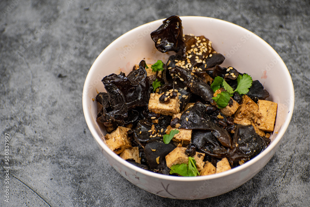 Wood ear mushroom and tofu bowl on gray table