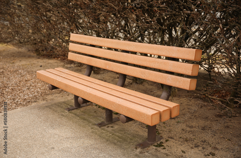 public bench in nature and city showing a colorful peace made of wood symbolizing morning environment
