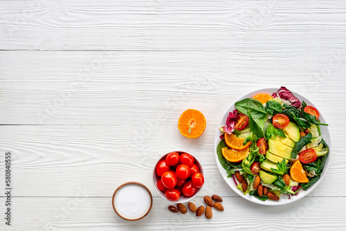 Healthy vegetarian bowl - green salad with avocado and tomatoes