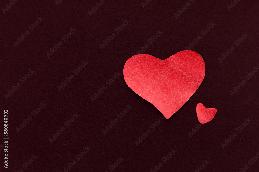 Two red heart on a black background, made of paper, romantic and festive beautiful symbol love Two red heart on a black background, made of paper, romantic and festive beautiful symbol love
