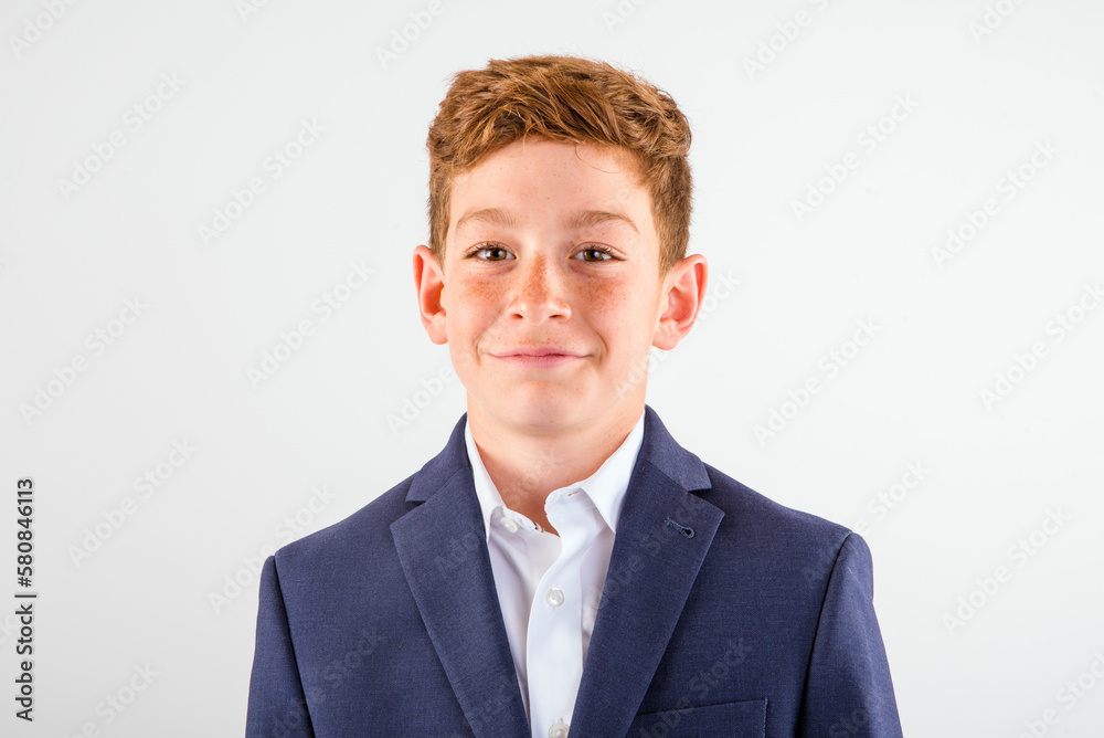 Head and shoulders portrait of a boy with freckles and red hair wearing a suit jacket Head and shoulders portrait of a boy with freckles and red hair wearing a suit jacket