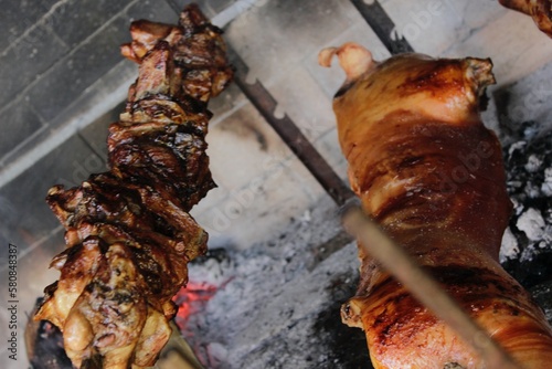 Grilled piglet and Sardinian suckling pig. Porceddu on the spit. Best red meat bbq party. Crunchy and toasted rind. Festival of roastyng and fire cooking photo