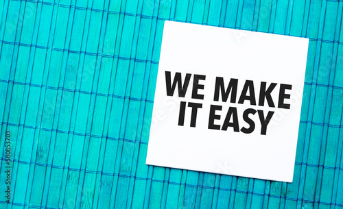 we make it easy word on torn paper with blue wooden background