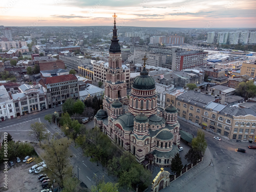 Holy Annunciation Cathedral aerial view with sunset golden cloudscape. Kharkiv city orthodox church in downtown, Ukraine