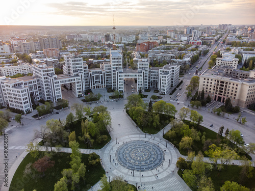 Sunset city aerial view on Derzhprom building and Freedom Square central fountain circle with epic golden cloudscape in Kharkiv  Ukraine