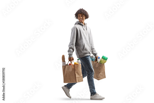 Cuadro en lienzo Full length portrait of a young african american man arrying grocery bags walkin