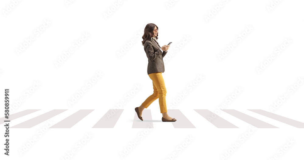 Young woman with a smartphone walking on a pedestrian crossing Young woman with a smartphone walking on a pedestrian crossing