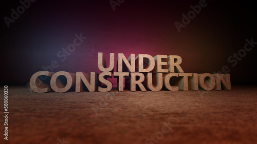 Under Construction sign 3d illustration. Concrete letters on the wall. Dramatic light