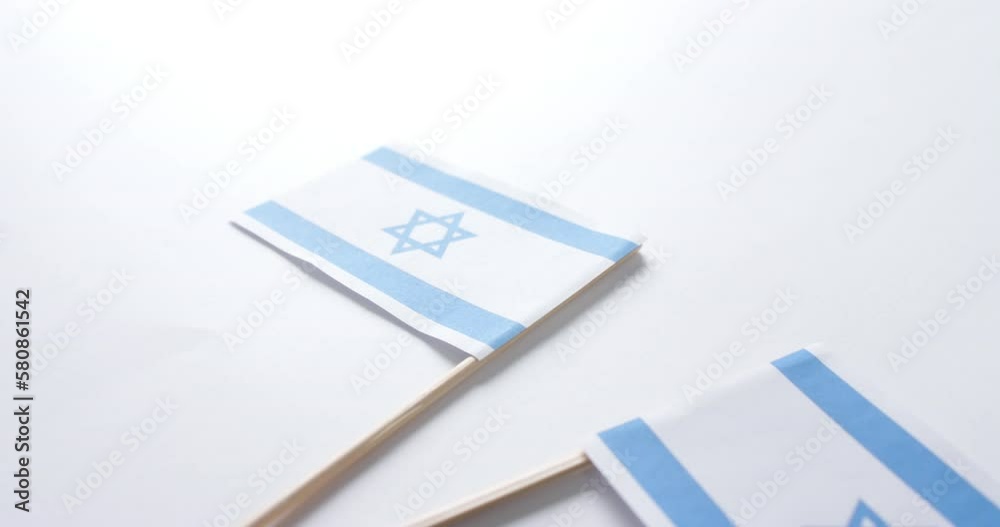 Close up of two flags of israel lying on white background Close up of two flags of israel lying on white background