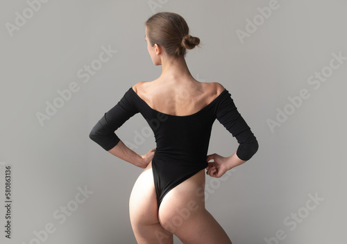 Sexy female back. Beautiful young body. Naked back of a woman with flexible body.