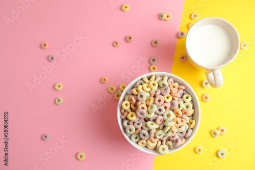 Multicolored corn rings for breakfast on a colored background