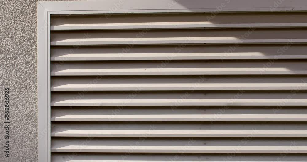 Ventilation grille for air movement in building. Air purification and suction technology. Security grille. Sunlight, shadow. Camera movement. Ventilation grille for air movement in building. Air purification and suction technology. Security grille. Sunlight, shadow. Camera movement.