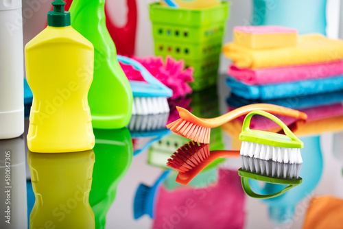 House cleaning. Set of colorful cleaning products on shining table.