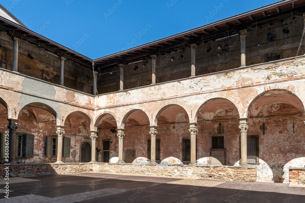 The two story cloister courtyard area of the 14th century Carmine Monastery in the historic Citta Alta upper town district of Bergamo, Italy.