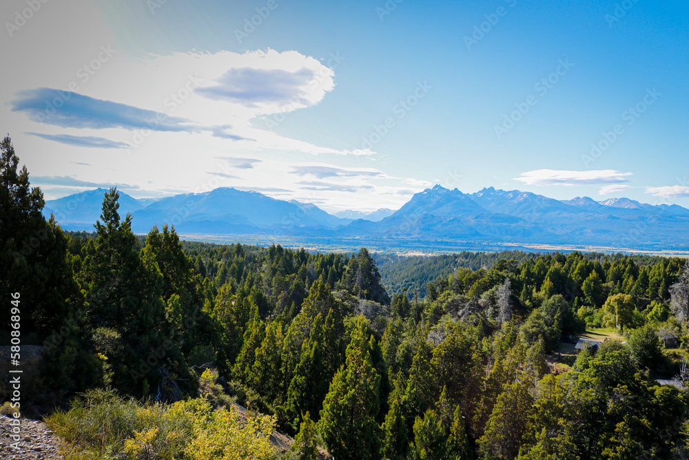 beautiful landscape with pine trees and mountains and blue sun. nature and tranquility