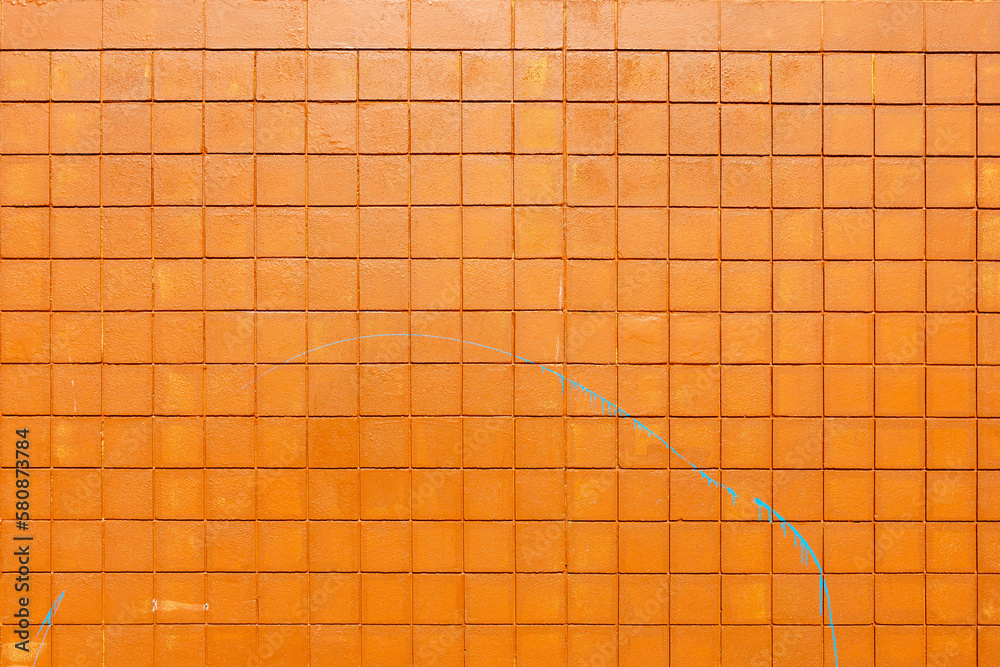 An abstract image of an exterior building wall constructed from small square orange bricks.  - obrazy, fototapety, plakaty 