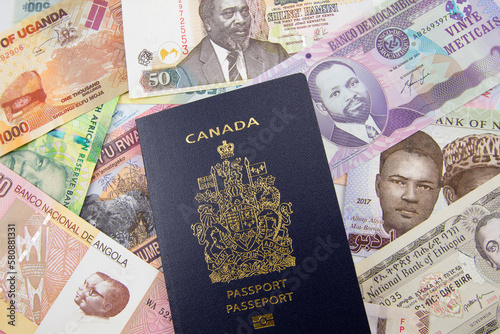 An Canadian passport on a background of African currency photo