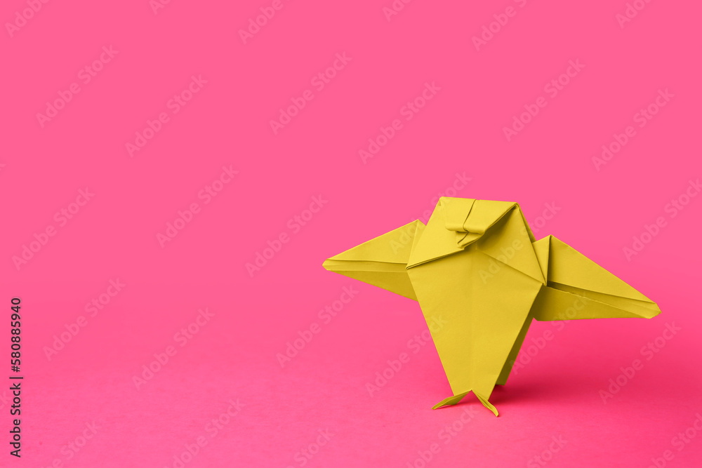 Origami art. Handmade green paper bird on pink background, space for text