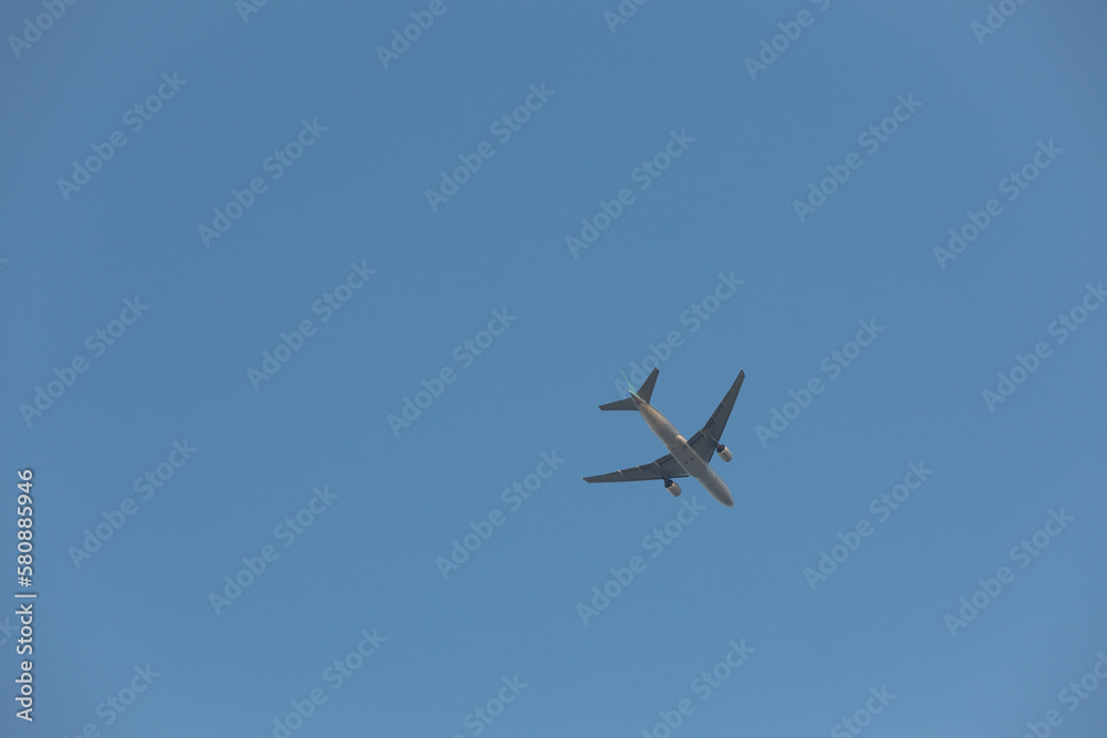 A plane flying across the clear sky. A plane flying across the clear sky.