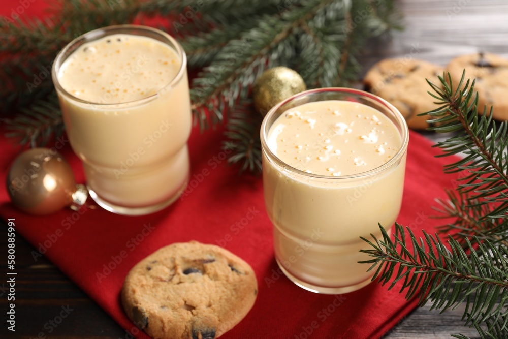 Tasty eggnog, cookies and fir branches on wooden table Tasty eggnog, cookies and fir branches on wooden table