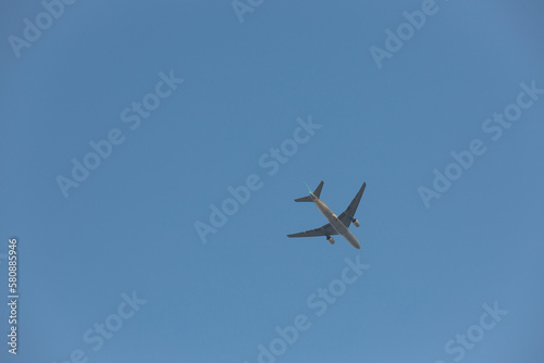 A plane flying across the clear sky.