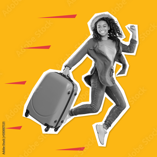 Cheerful millennial black woman tourist in casual with suitcase enjoys vacation, jumping, freezes in air