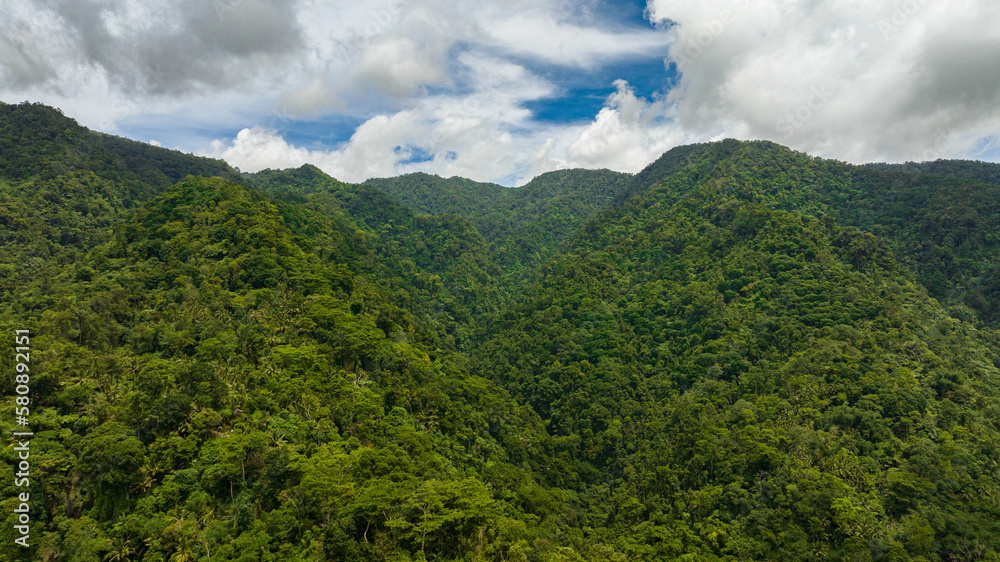 Aerial drone of mountain range and mountain slopes with rainforest. Philippines, Negros island.