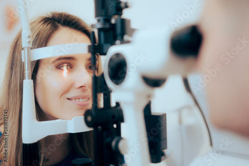 Patient During Eye Examination with the Ophthalmologist in a Clinic. Doctor examining and measuring for proper diagnoses with a binocular slit-lamp 