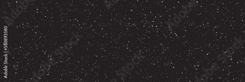 Snowfall on a black background. Flying dust particles on a black background