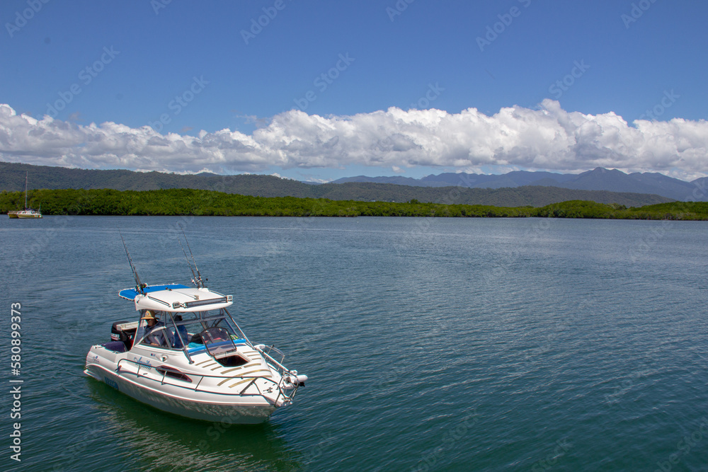 Port Douglas Cairns Australia beach with boat Port Douglas Cairns Australia beach with boat