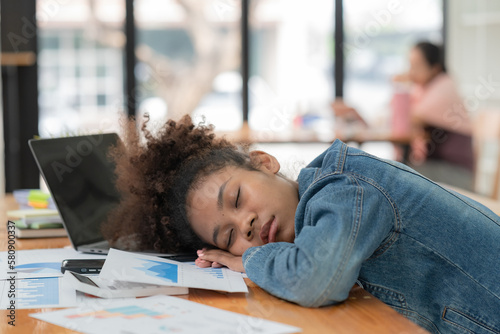 Sleep, burnout or business woman sleeping in office, sick or stress with work depression or mental health fatigue. Tired, anxiety or black woman frustrated, lazy or sleepy at desk in office.