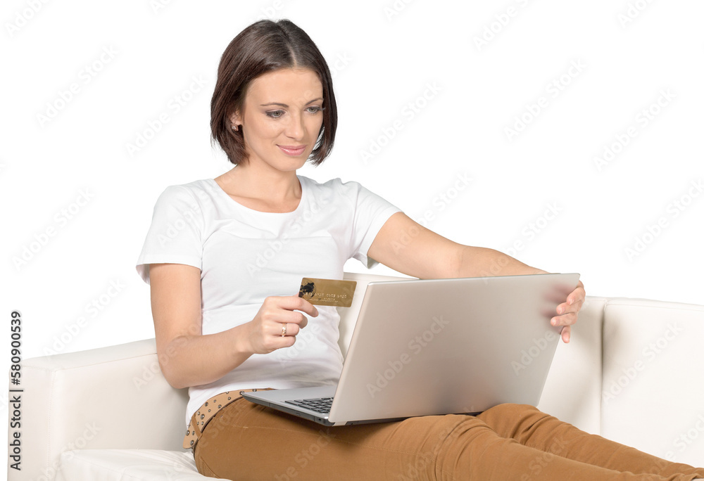 Woman Sitting on a Couch with Laptop and a Credit Card Woman Sitting on a Couch with Laptop and a Credit Card