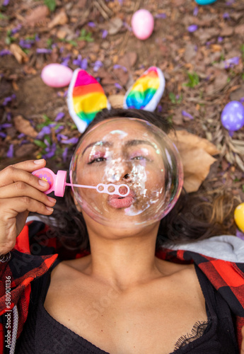 Bubble Therapy in the Woods: Woman Relaxing and Blowing Bubbles on the Ground