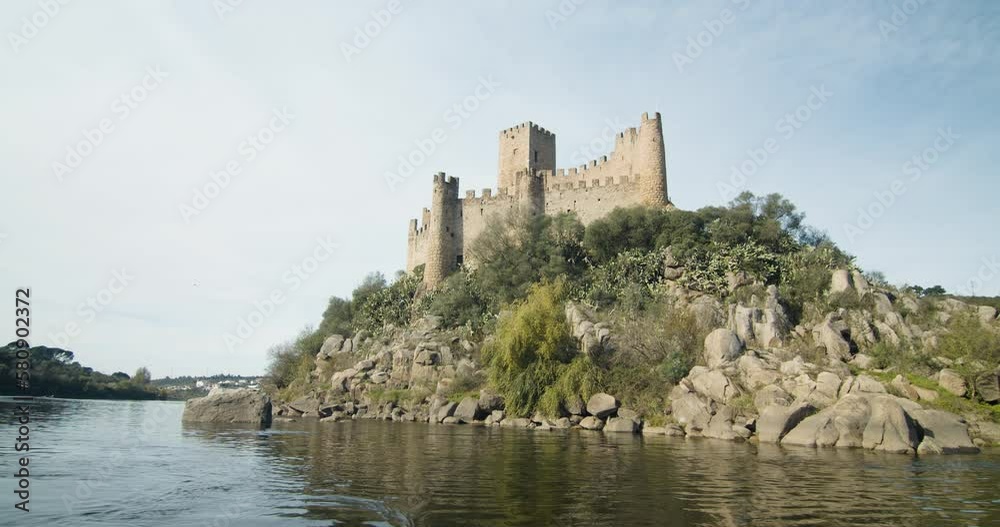 Amazing Epic Medieval Castle by the river bank. Almourol castle. Floating with the stream, approaching the castle. Ribatejo, Portugal Amazing Epic Medieval Castle by the river bank. Almourol castle. Floating with the stream, approaching the castle. Ribatejo, Portugal