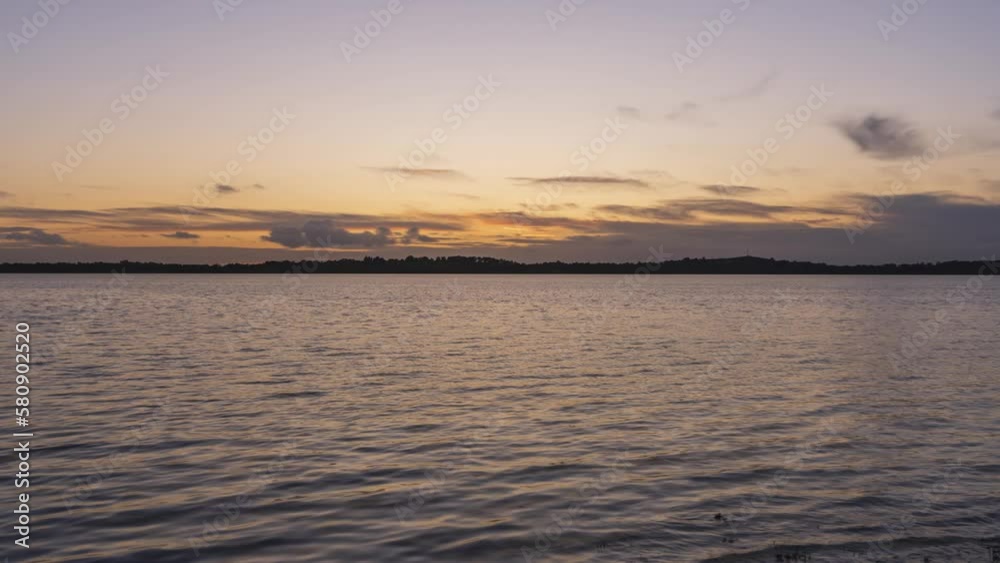 Timelapse of local lake in county Westmeath in Ireland during sunset with clouds above the horizon. Timelapse of local lake in county Westmeath in Ireland during sunset with clouds above the horizon.