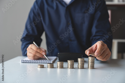Businessmen, retirees, modern youths build their fortunes stacking coins on top of the highest row. Saving money for business growth. Investment. Savings. Concept of saving money for investment.