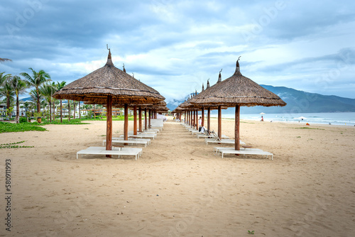 Fototapeta Naklejka Na Ścianę i Meble -  The umbrellas and chairs by the seaside Bai Dai in Khanh Hoa province, Vietnam