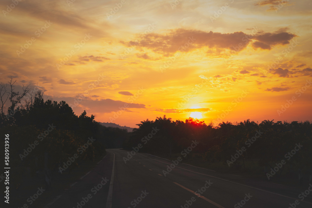 asphalt road at sunset