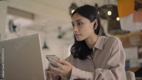 Asian freelancer cell cafe. Busy person use computer macbook coworking place. Boss woman look screen monitor. People study iphon network. Female user start up laptop desk. Coworker girl job home space