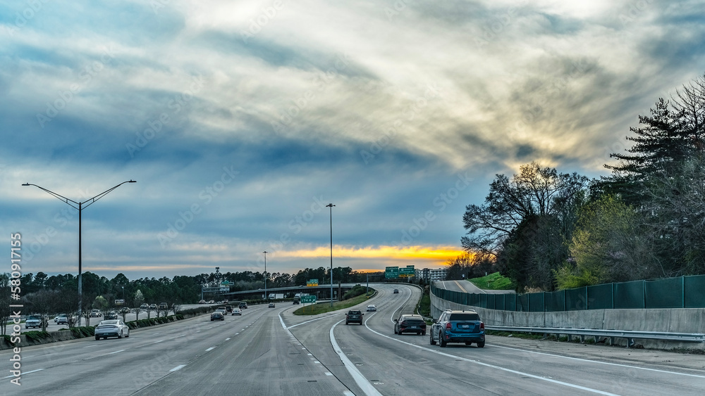 Traffic on a highway at sunset.