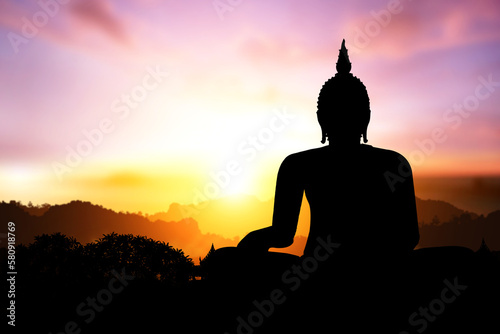 Silhouette of Buddha on mountain in sunset light © sakepaint