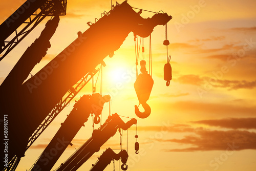 silhouette crane truck in flare light for logistic background  photo
