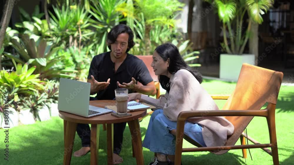 Asian people use computer online video call. Colleagues distant work together open air. Man girl discuss start up. Teamwork laptop job conference. Team meet palm tree cafe. Guy user virtual chat talk.