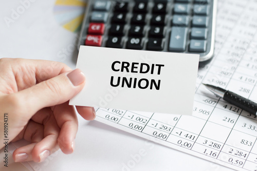 Fotomurale Credit Union text on a card in the hand of a businessman on the background of an