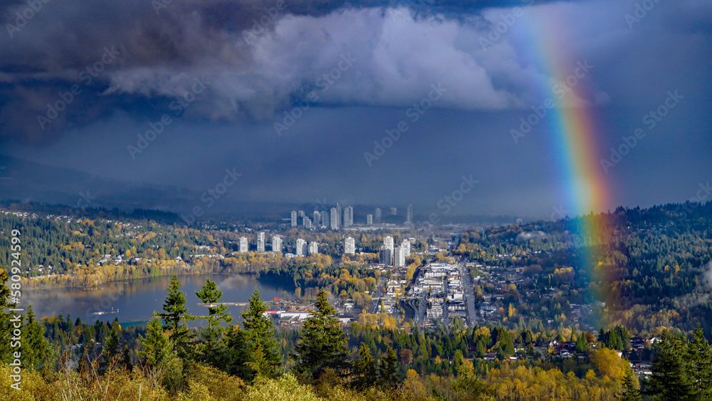 Late afternoon rainbow against dramatic storm clouds at Port Moody, BC.