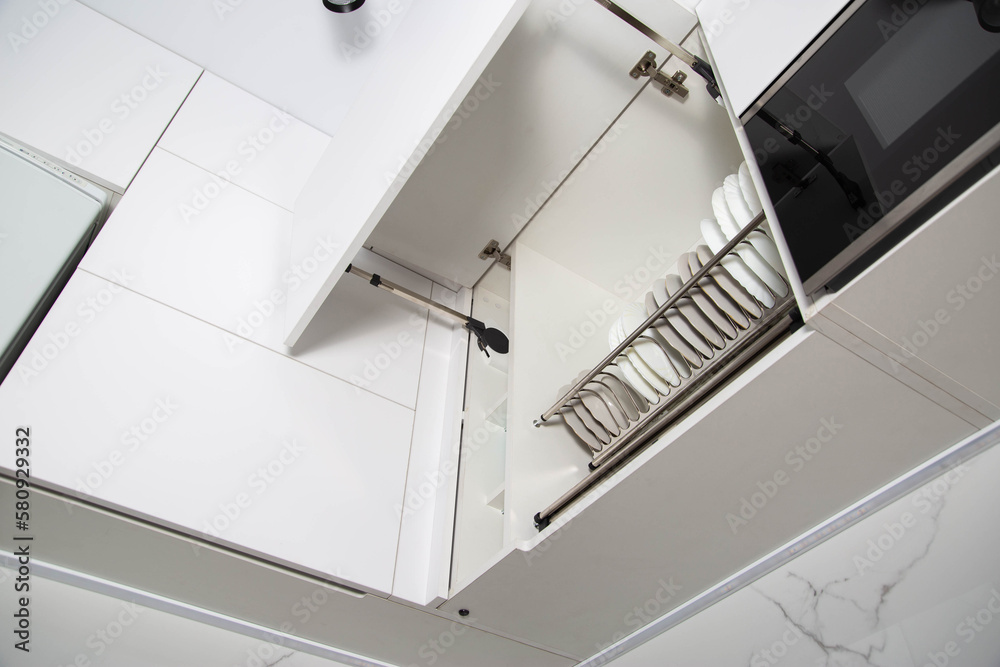 Modern lifting mechanism of the door of the facade of the kitchen. Storage of dishes in a separate section, kitchen system Modern lifting mechanism of the door of the facade of the kitchen. Storage of dishes in a separate section, kitchen system