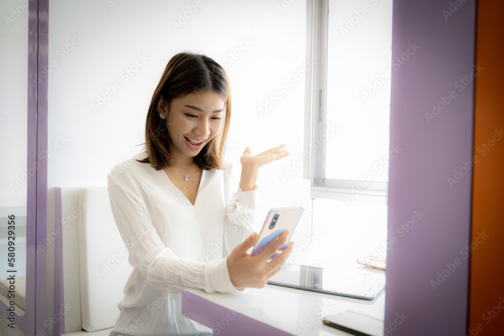 Beautiful asian businesswoman making more sales than the norm in Beautiful asian businesswoman making more sales than the norm in