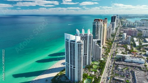 Expensive highrise hotels and condos on Atlantic ocean shore in Sunny Isles Beach city and busy street traffic. American tourism infrastructure in southern Florida photo